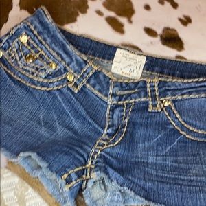 Short shorts cut off edge with plastic gem buttons